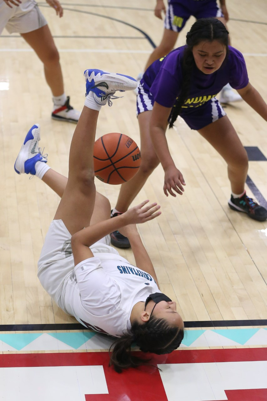 Shiprock's Harmony Sells attempts to keep the ball in play against Monument Valley's Shimegua Hudson in the closing minute of the girls semifinal game of the Jerry Richardson Memorial Tournament at the Chieftain Pit on Friday, December 2, 2022.