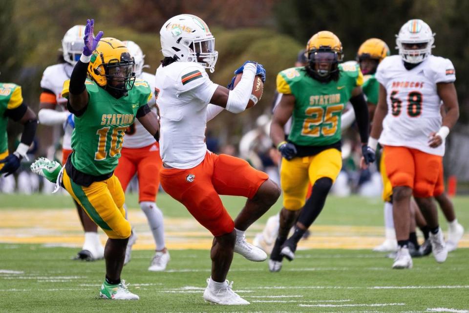 Frederick Douglass wide receiver Aveion Chenault, center, catches a pass against Bryan Station on Saturday, Oct. 14, 2023.