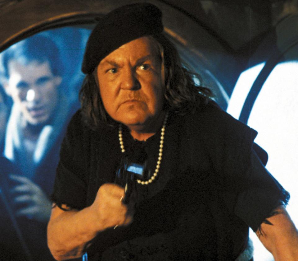 Mama Fratelli holding a gun