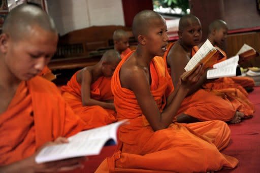 Buddhist novice monk and aspiring ladyboy Pipop Thanajindawong (C), seen here reciting prayers at the Wat Kreung Tai temple in Thailand's northern border town of Chiang Khong. The temple has run a course to teach masculinity to boys who are "katoeys", the Thai term for transsexuals or ladyboys, aged between 11 and 18, since 2008