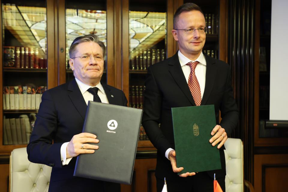 Alexey Likhachev, Rosatom director, left, and Peter Szijjarto, Hungarian trade minister, pose after signing a document during their meeting in Moscow (AP)