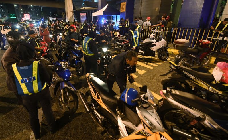 RTD personnel conduct checks on motorcyclists during an operation in Bangsar February 19, 2018. — Bernama pic