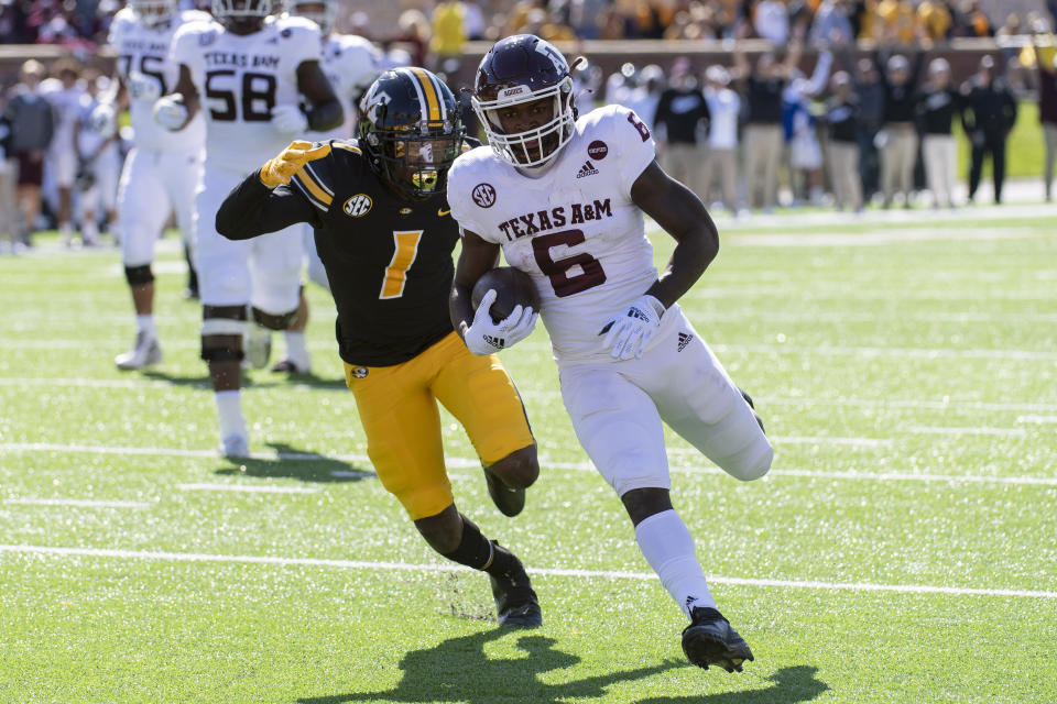 Texas A&M running back Devon Achane, right, scores a touchdown in front of Missouri's Jaylon Carlies, left, during the first quarter of an NCAA college football game Saturday, Oct. 16, 2021, in Columbia, Mo. (AP Photo/L.G. Patterson)