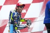 Yamaha MotoGP rider Valentino Rossi of Italy celebrates his victory on the podium after winning the MotoGP the race at the TT Assen Grand Prix at Assen, Netherlands June 27, 2015. REUTERS/Ronald Fleurbaaij