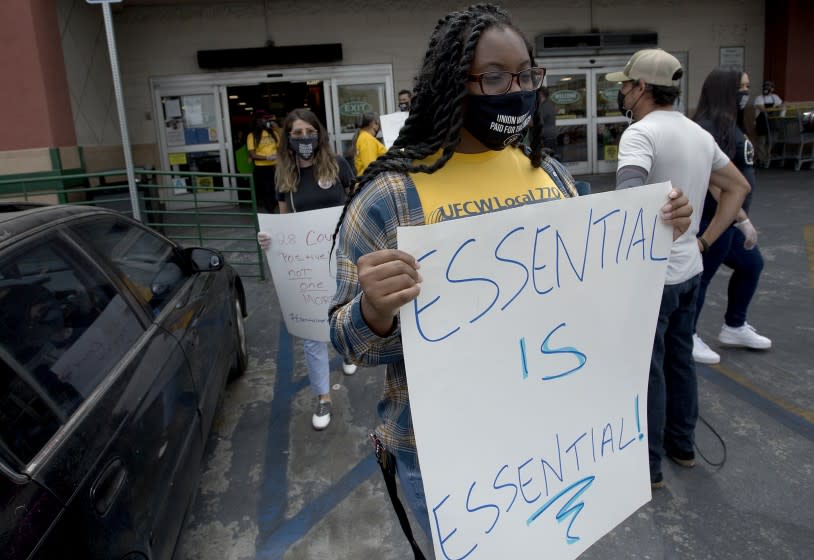 LOS ANGELES, CA - AUG.5, 2020. Grocery workers associated with UFCW Local 770 demonstrate Wednesday, Aug. 5, 2020, outside a Food 4 Less store in Los Angeles where 28 workers have allegedly become infected with COVID-19. The demonstrators called on Kroger, the parent company of Food 4 Less, to ensure safety measures in stores by providing regular COVID-19 testing, providing clear and timely information about infections and the inclusion of worker councils. (Luis Sinco/Los Aneles Time)