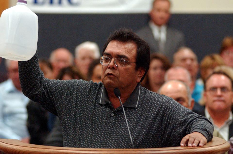 Antonio Ramos, of El Centro, California, holds up a gallon-size bottle, representing Imperial County’s water, during a 2002 meeting on a proposal to transfer water from Imperial Valley farms to San Diego County.