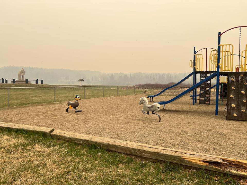A playground in the community of Charlie Lake, 10 kilometres northeast of Fort St. John, is blanketed by smoke on Saturday, the day evacuees headed to the community to escape a wildfire near Fort Nelson.