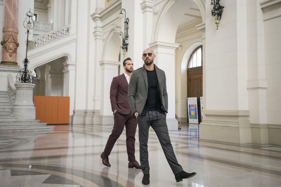 Andrew Tate, right, and his brother Tristan, left, walk inside the Court of Appeals building in Bucharest, Romania, Tuesday, Jan. 30, 2024. (AP Photo/Vadim Ghirda)