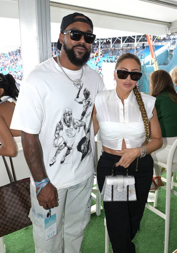 Marcus and Larsa stand together for a photo at a sporting event