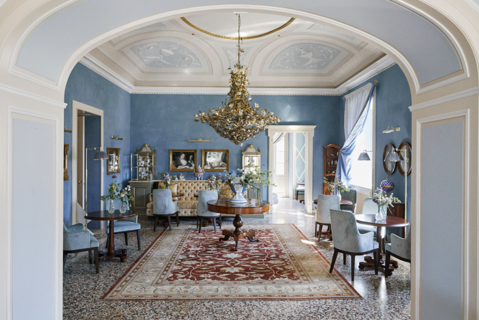 a room with a chandelier and chairs