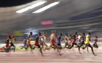 Competitors race in the men's 10,000 meter final at the World Athletics Championships in Doha, Qatar, Sunday, Oct. 6, 2019. (AP Photo/Petr David Josek)