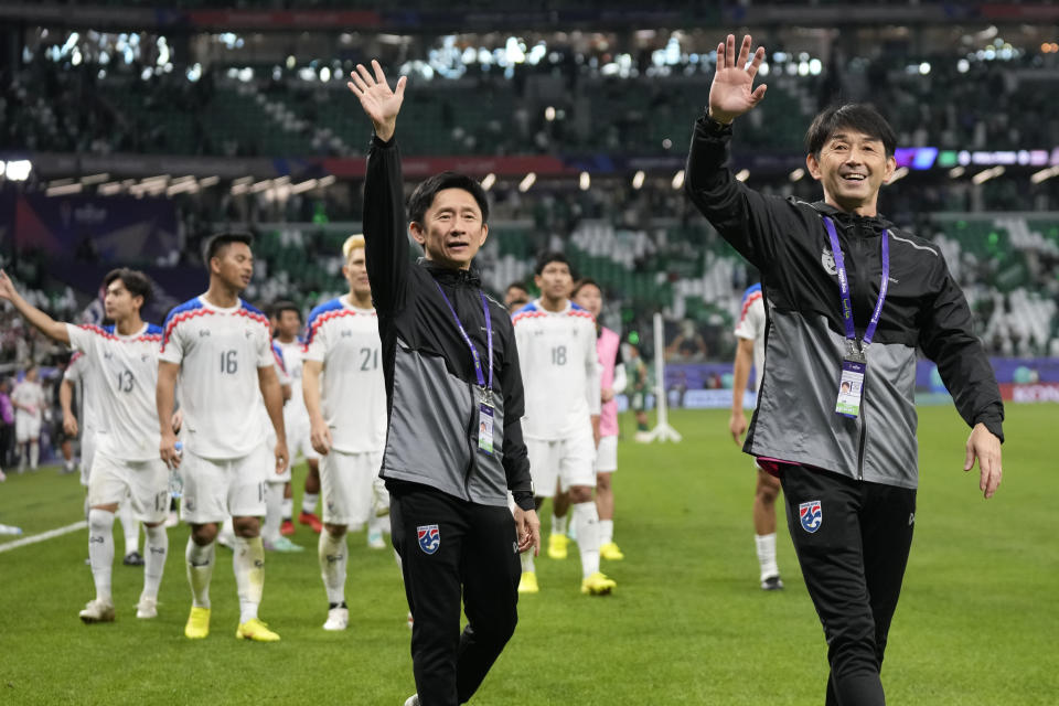 Thailand's head coach Ishii Masatada, right, waves to the fans after the Asian Cup Group F soccer match between Saudi Arabia and Thailand at Education City Stadium, in Al Rayyan, Qatar, Thursday, Jan. 25, 2024. The match ended 0-0. (AP Photo/Aijaz Rahi)