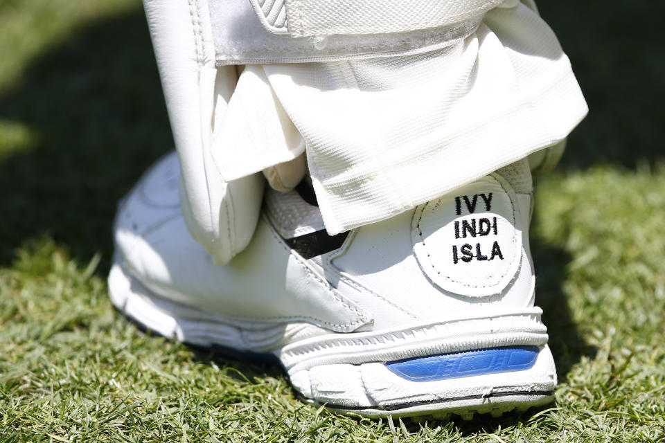 Australia's David Warner has the names of his daughters Ivy Mae, 5, Indy Rae, 3, and Isla Rose, 5 months, embroidered on his shoes as his inspiration during their cricket test match against Pakistan in Brisbane, Australia, Saturday, Nov. 23, 2019. (AP Photo/Tertius Pickard)