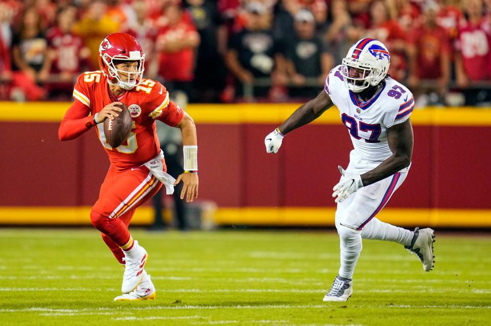 Kansas City Chiefs quarterback Patrick Mahomes scrambles from Buffalo Bills defensive end Mario Addison.