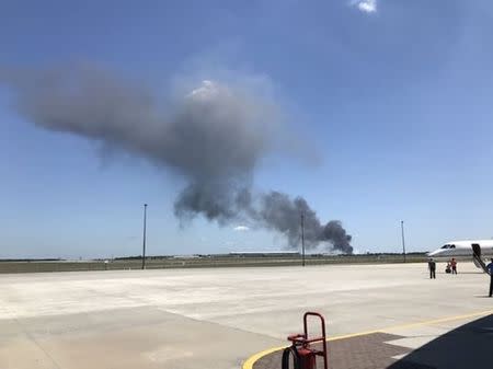 Smoke rises from an airplane crash near Savannah airport, Georgia, U.S., May 2, 2018 in this picture obtained from social media. INSTAGRAM/@PILOTGABE/via REUTERS