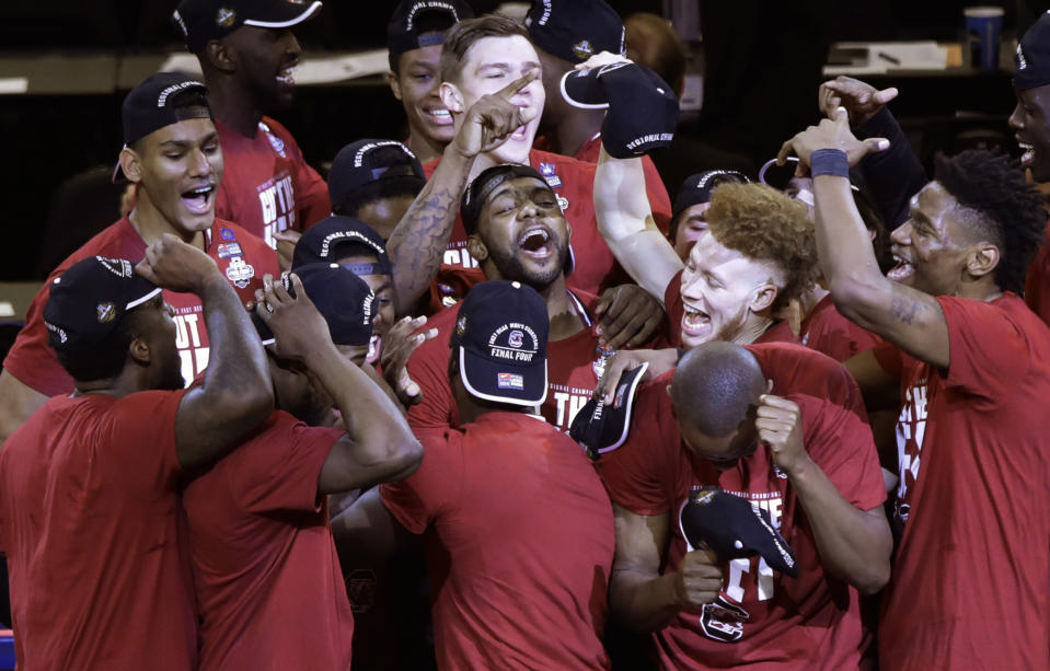 South Carolina players celebrate after beating Florida 77-70 in the East Regional championship game of the NCAA men's college basketball tournament, Sunday, March 26, 2017, in New York. (AP Photo/Frank Franklin II)