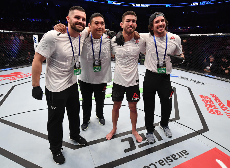 BEIJING, CHINA - NOVEMBER 24:  Louis Smolka poses for photos with his team after his victory over Su Mudaerji in their bantamweight bout during the UFC Fight Night event inside Cadillac Arena on November 24, 2018 in Beijing, China. (Photo by Jeff Bottari/Zuffa LLC/Zuffa LLC via Getty Images)
