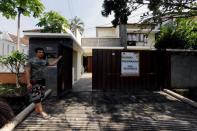 A house guard stands in front of an empty rental house at Kemang district in Jakarta, Indonesia, June 23, 2016. REUTERS/Bewiharta