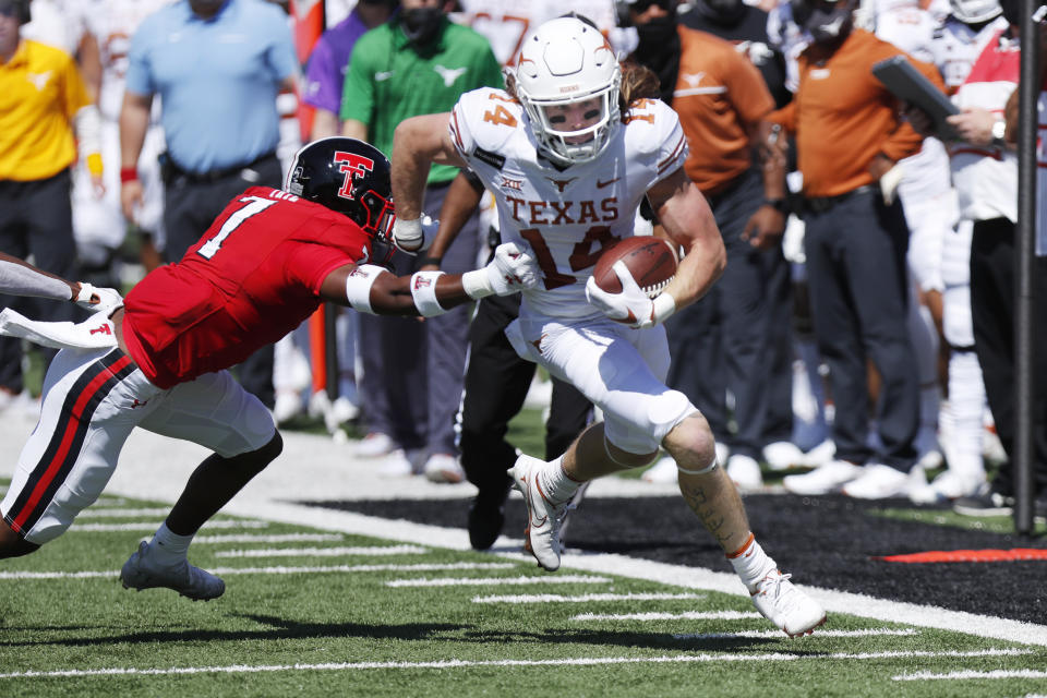 Texas wide receiver Dajon Harrison is pushed out of bounds by Texas Tech defensive back Caden Sterns during the first half of an NCAA college football game against Texas Tech, Saturday Sept. 26, 2020, in Lubbock, Texas. (AP Photo/Mark Rogers)