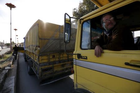 A convoy carrying humanitarian goods wait to enter the besieged area of Moudamiya Al Sham in the suburbs of Damascus, Syria February 17, 2016. REUTERS/Omar Sanadiki