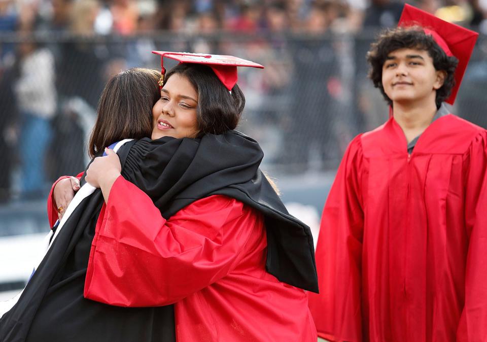 Homeroom teacher Jennifer Shaw shares a warm hug with student Naiara Bautista Bates. North Quincy High graduation exercises at Veterans Stadium on Tuesday June 6, 2023