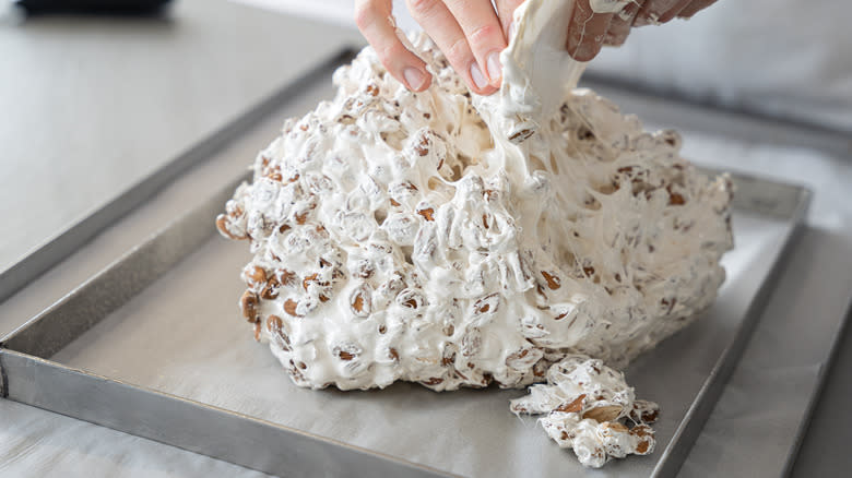 hands shaping white nougat batter