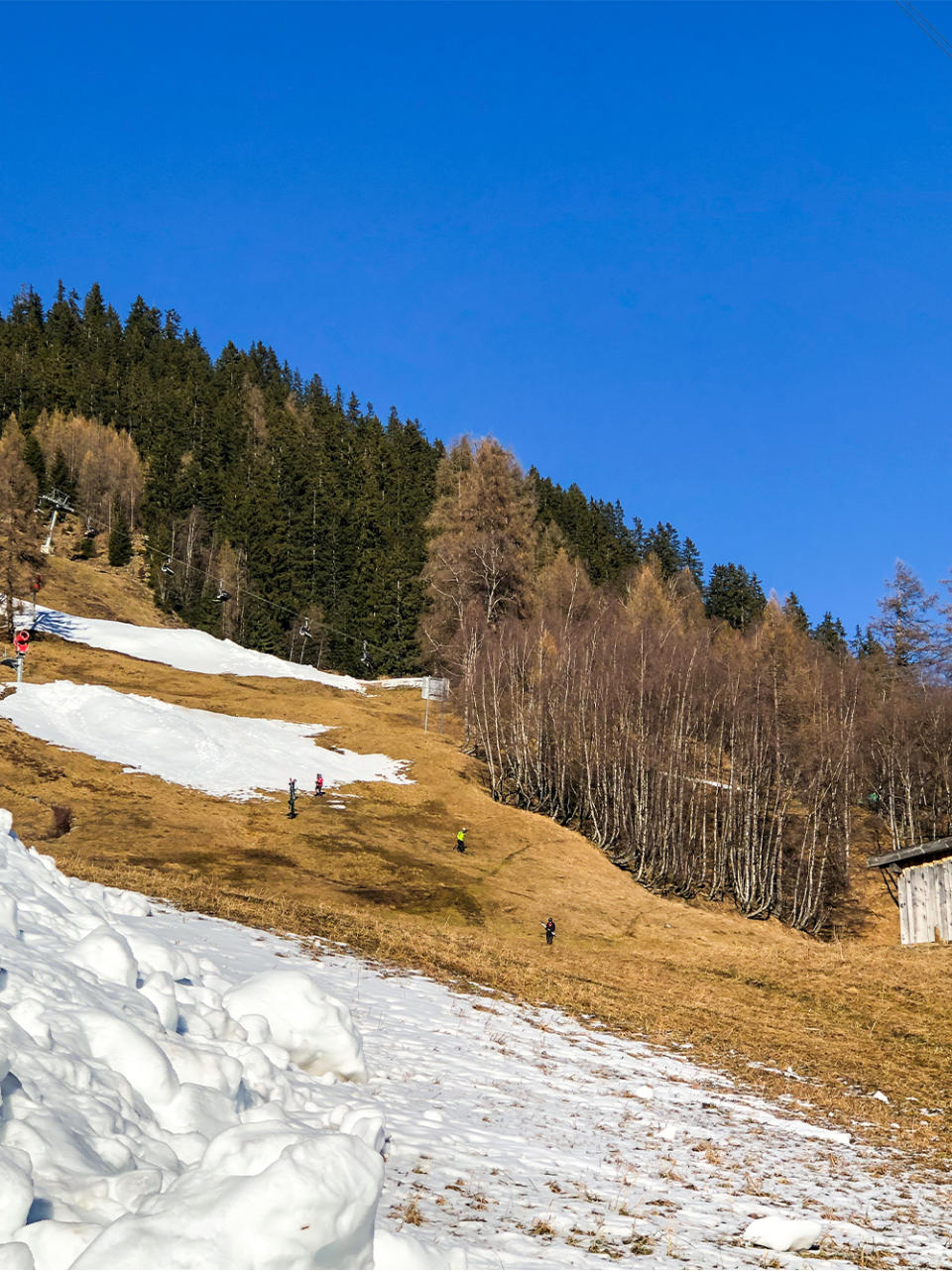Snowless ski runs like this one in the Alps have become a common sight this year.
