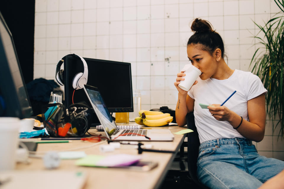 Young businesswoman drinking coffee