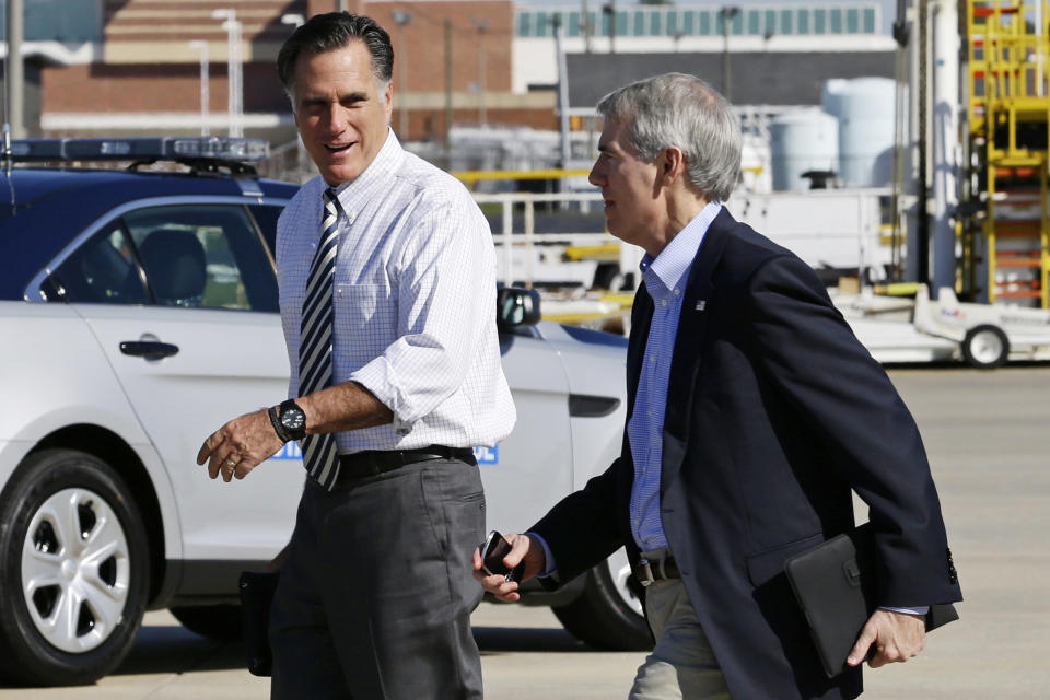 Republican presidential candidate, former Massachusetts Gov. Mitt Romney walks with Sen. Rob Portman, R-Ohio, as he arrives in Richmond, Va., Friday, Oct. 12, 2012. (AP Photo/Charles Dharapak)