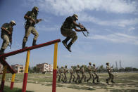 Special police officer recruits who completed nearly three months physical training demonstrate their skills at Kathua in Indian-controlled Kashmir, Saturday, June 5, 2021. Special police officers are lower-ranked police officials who are mainly recruited for intelligence gathering and counterinsurgency operations. In recent years, the force has assisted in border areas as well because of local recruits' familiarity with the topography and ability to assist police and border guards during emergencies. (AP Photo/Channi Anand)