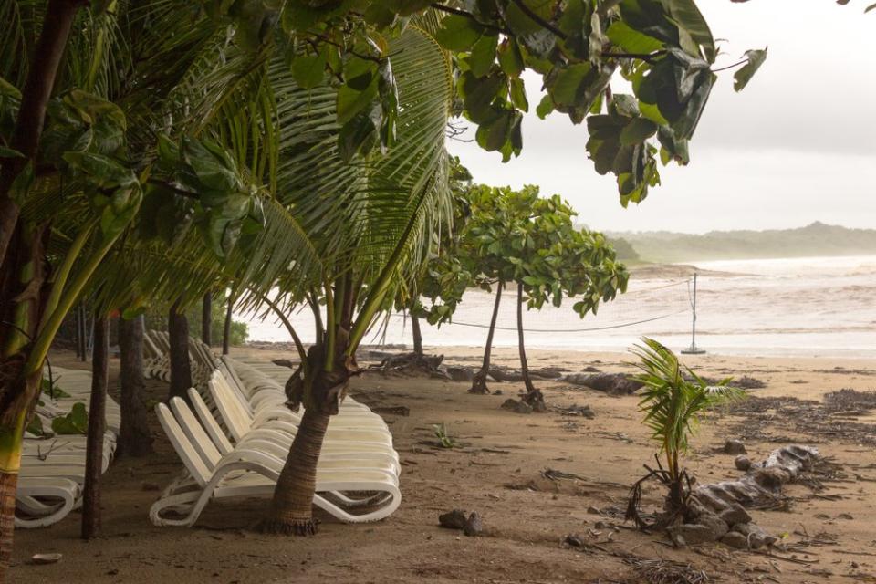 Playa Langosta, Costa Rica with white chairs on the beach