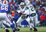 Tim Tebow #15 of the New York Jets hands the ball off to Joe McKnight #25 during an NFL game against the Buffalo Bills at Ralph Wilson Stadium on December 30, 2012 in Orchard Park, New York. (Photo by Tom Szczerbowski/Getty Images)