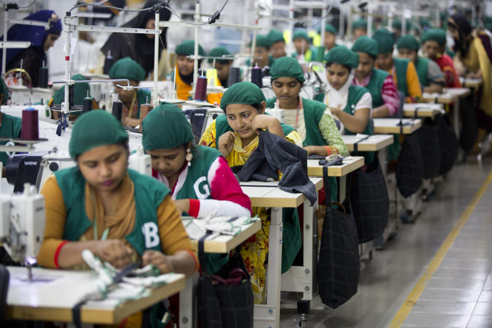 FILE - In this April 19, 2018 file photo, trainees work at Snowtex garment factory in Dhamrai, near Dhaka, Bangladesh. After months of decline in exports of its garment products, Bangladesh’s economy is showing signs of recovery. The Asian Development Bank in a new report said Tuesday, Sept. 15, 2020, the country's economy's comeback was encouraging and it is expected to grow by 6.8 percent in the current fiscal year ending in June if this recovery sustains. (AP Photo/A.M. Ahad, File)