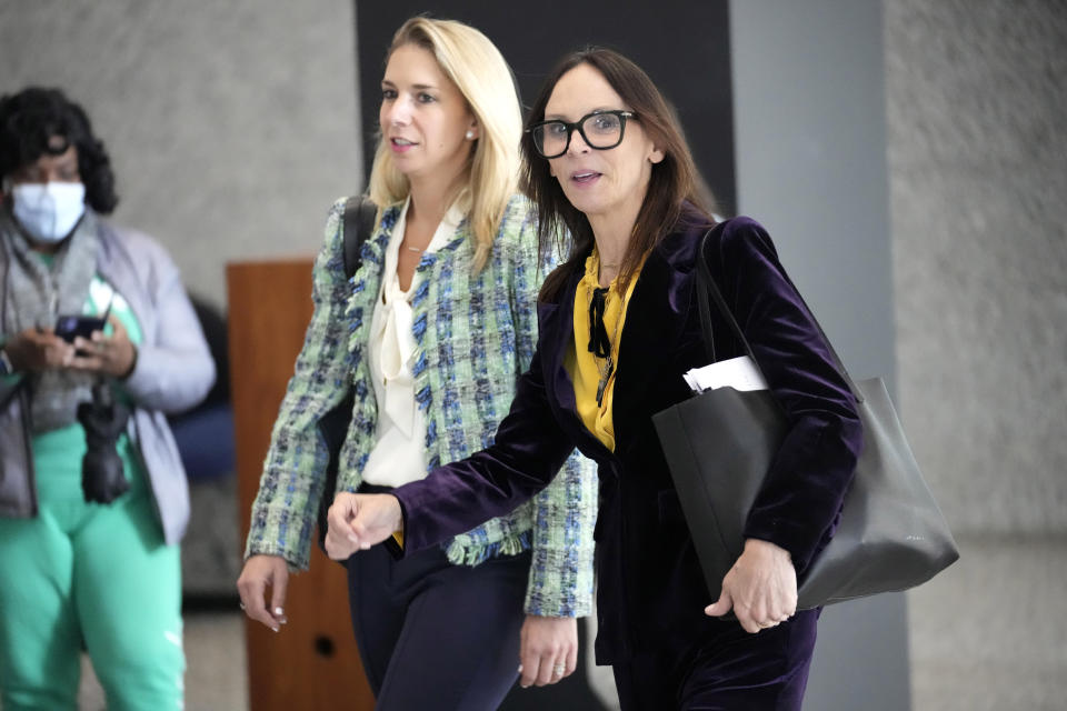 Attorneys for R. Kelly, Jennifer Bonjean, right, and Ashley Cohen make their way to reporters at the Dirksen Federal Building after Kelly's sentencing hearing Thursday, Feb. 23, 2023, in Chicago. R. Kelly was sentenced on Thursday to 20 years in prison for child pornography and enticement of minors for sex but will serve all but one of those simultaneously with a 30-year sentence on racketeering and sex trafficking convictions. (AP Photo/Charles Rex Arbogast)