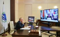 Russian President Vladimir Putin takes part in the Shanghai Cooperation Organization (SCO) meeting in Dushanbe, Tajikistan via videoconference at the Novo-Ogaryovo residence outside Moscow, Russia, Friday, Sept. 17, 2021. Tajikistan President Imomali Rakhmon is on the screen. (Alexei Druzhinin, Sputnik, Kremlin Pool Photo via AP)