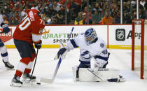 Florida Panthers right wing Patric Hornqvist (70) crashes the net as Tampa Bay Lightning goaltender Andrei Vasilevskiy (88) defends during the second period of Game 1 of an NHL hockey second-round playoff series Tuesday, May 17, 2022, in Sunrise, Fla. (AP Photo/Reinhold Matay)