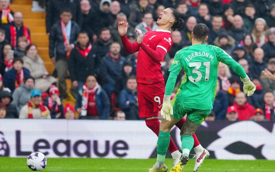 Manchester City's goalkeeper Ederson, right, stops Liverpool's Darwin Nunez during the English Premier League