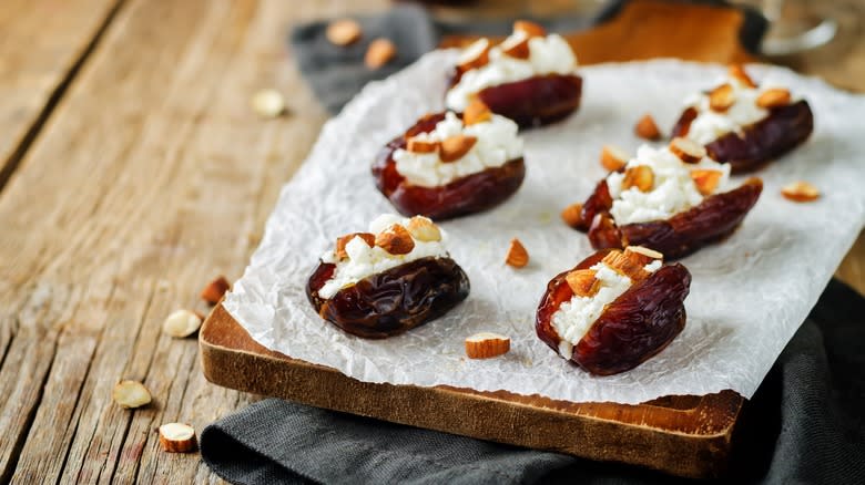 Stuffed dates on wooden board