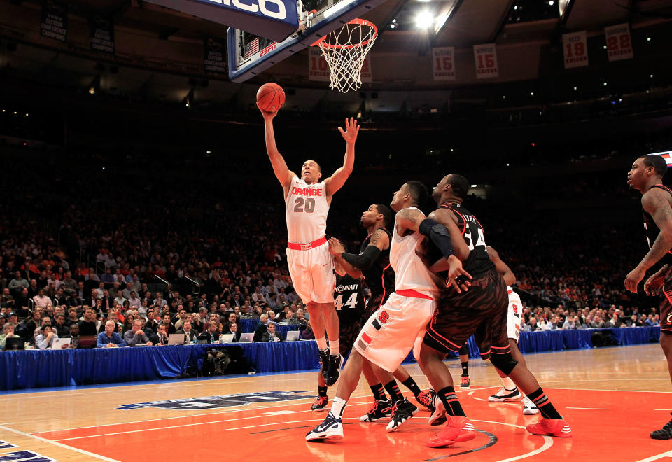 NEW YORK, NY - MARCH 09: Brandon Triche #20 of the Syracuse Orange drives to the basket against Dion Dixon #3 of the Cincinnati Bearcats during the semifinals of the Big East men's basketball tournament at Madison Square Garden on March 9, 2012 in New York City. (Photo by Chris Trotman/Getty Images)