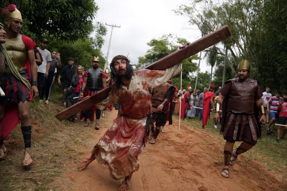 Faithful reenact the Way of the Cross in Atyra, Paraguay Friday, April 7, 2023. Holy Week commemorates the last week of the earthly life of Jesus Christ culminating in his crucifixion on Good Friday and his resurrection on Easter Sunday. (AP Photo/Jorge Saenz)