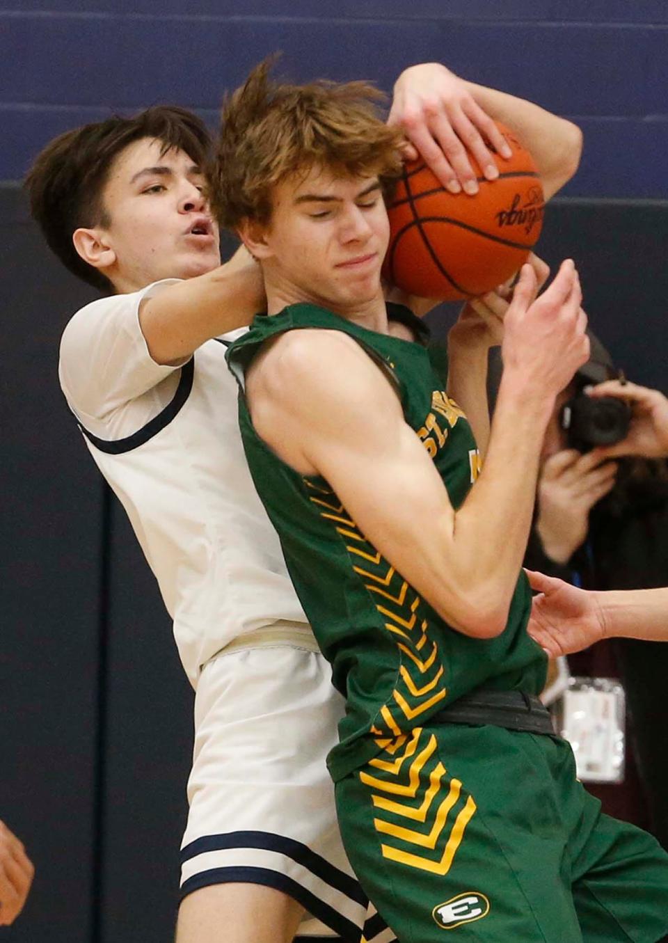 Archbishop Hoban's Andrew Griffith, left, and Lakewood St. Edward's Cam Grant battle for a rebound during the third period of their Division I regional final Saturday at Copley. St. Edward won 63-46. [Karen Schiely/Beacon Journal]