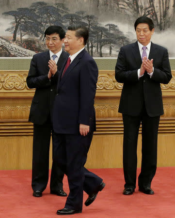 China's President Xi Jinping (C) walks past new Politburo Standing Committee members Li Zhanshu (R) and Wang Huning during a meeting with the media at the Great Hall of the People in Beijing, China October 25, 2017. REUTERS/Jason Lee