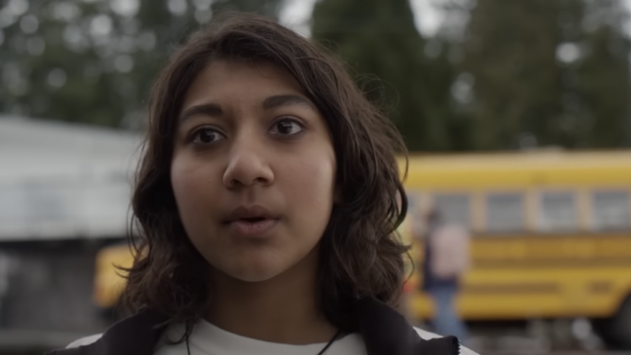 a woman with a bus in the background