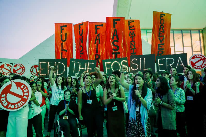 FILE PHOTO: Climate activists protest against fossil fuels at Dubai's Expo City during COP28, in Dubai