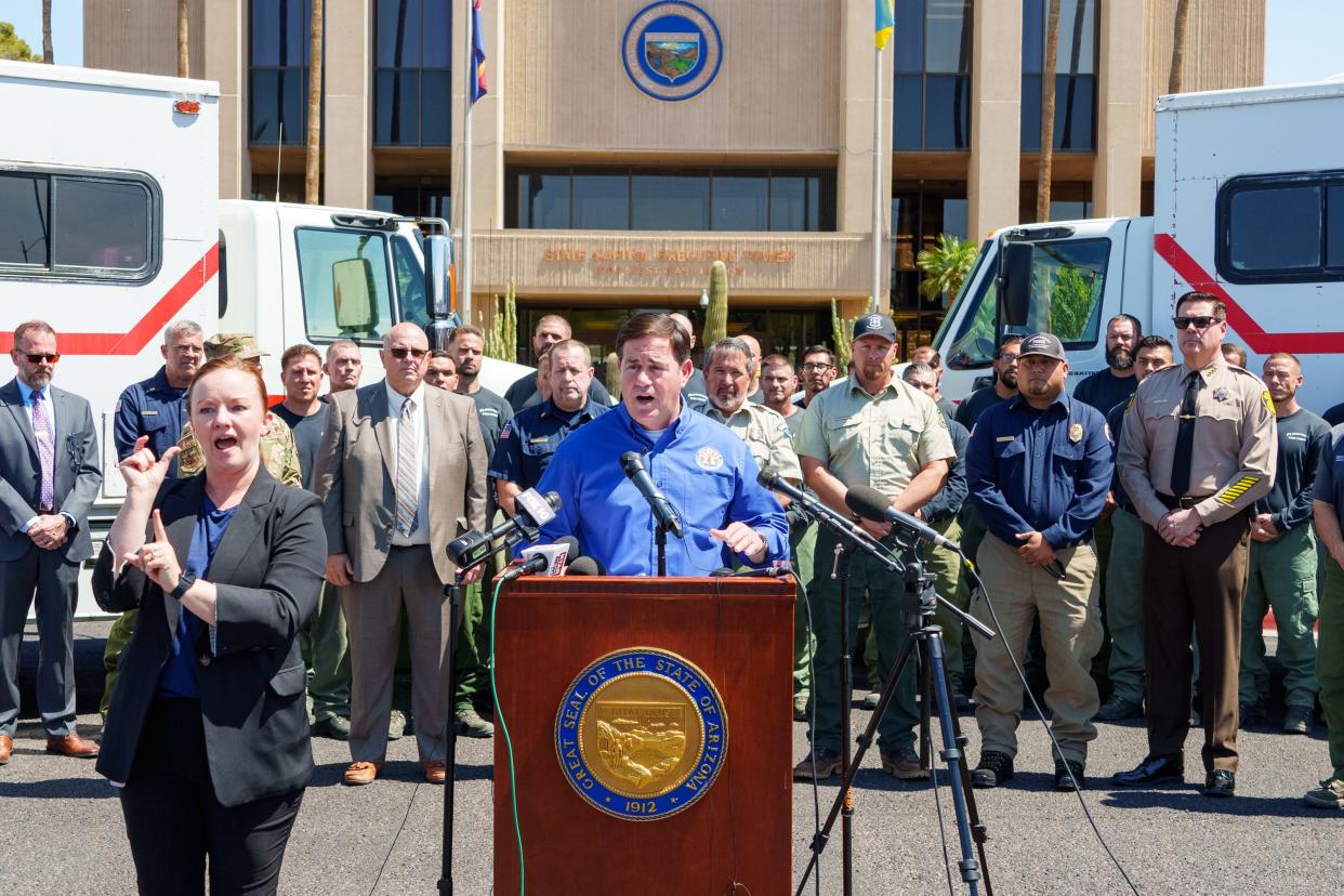 Gov. Doug Ducey gives a briefing on wildfire safety at the state Capitol as members of the Wildland Fire Crew stand behind him on March 31, 2022, in Phoenix, Ariz.