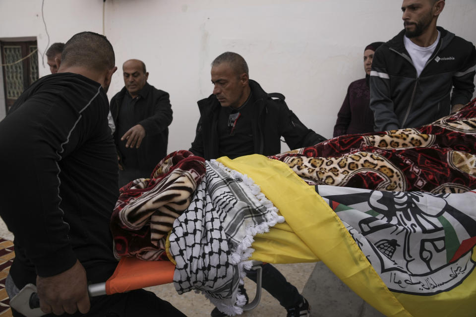 Mourners carry the body of Palestinian Fulla al-Masalmeh,15, during her funeral in the West Bank village of Beit Awwa, Tuesday, Nov. 15, 2022. The Palestinian Health Ministry says Israeli forces shot and killed a 15-year-old Palestinian girl during a pre-dawn raid in the occupied West Bank. The circumstances surrounding the death of the teenage girl in the city of Beitunia in the central West Bank, identified by Palestinian health officials as Fulla al-Masalmeh, were not fully clear. The Israeli military said soldiers opened fire on a vehicle that was accelerating toward them after they signaled for it to stop. The military said it was investigating, and declined to comment further. (AP Photo/Mahmoud Illean)