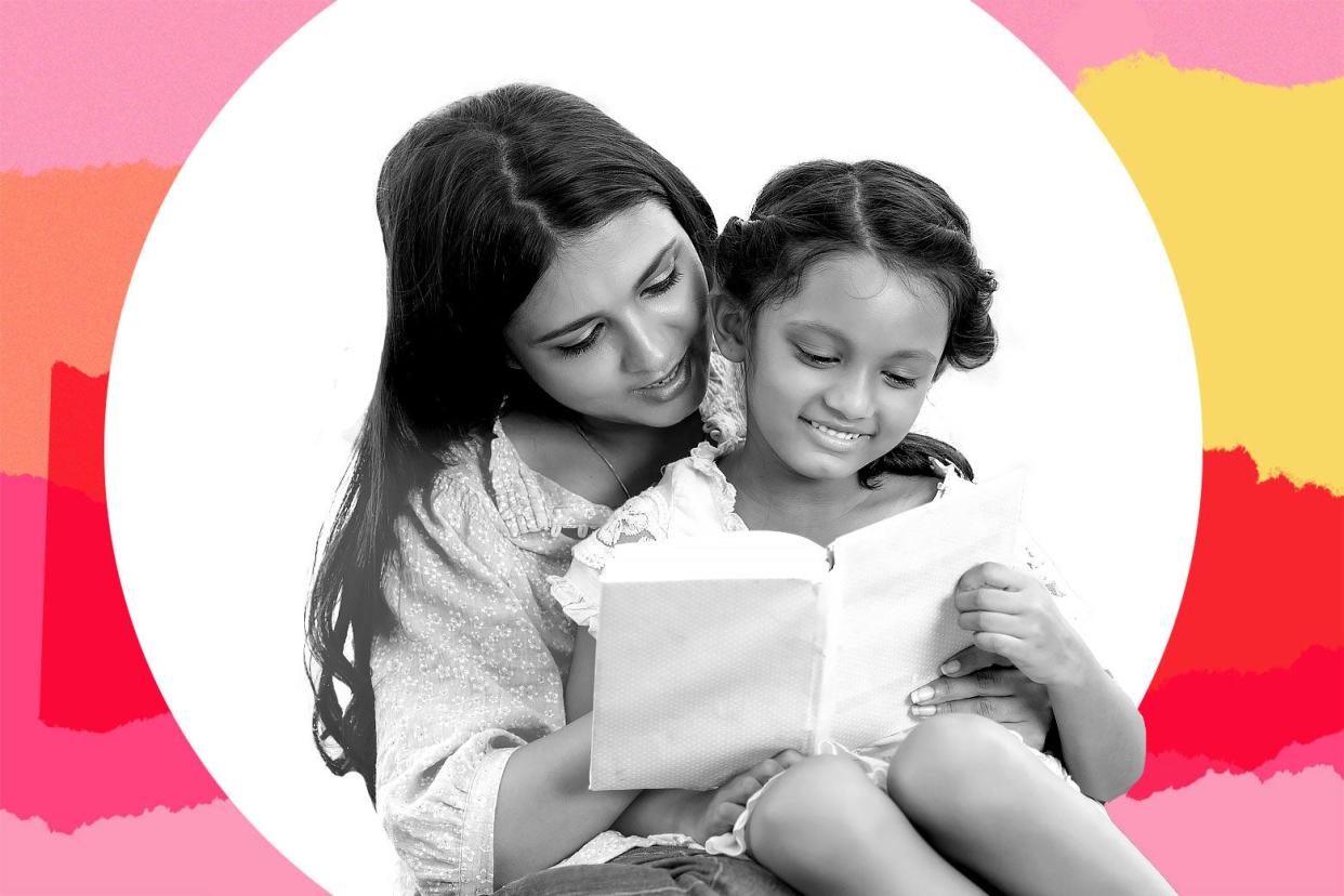 A mother and daughter reading a book.
