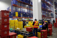 Employees work at RedMart's fulfillment centre in Singapore September 22, 2017. REUTERS/Edgar Su