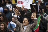 Sima Mohair, foreground center, participates in a rally calling for regime change in Iran following the death of Mahsa Amini, a young woman who died after being arrested in Tehran by Iran's notorious "morality police," in Washington, Saturday, Oct. 1, 2022. (AP Photo/Cliff Owen)