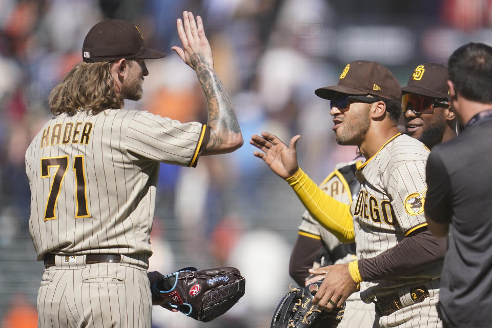 San Diego Padres' Josh Hader (71) celebrates with Trent Grisham, second from right, and Jurickson Profar after the Padres defeated the San Francisco Giants in a baseball game in San Francisco, Wednesday, Aug. 31, 2022. (AP Photo/Jeff Chiu)